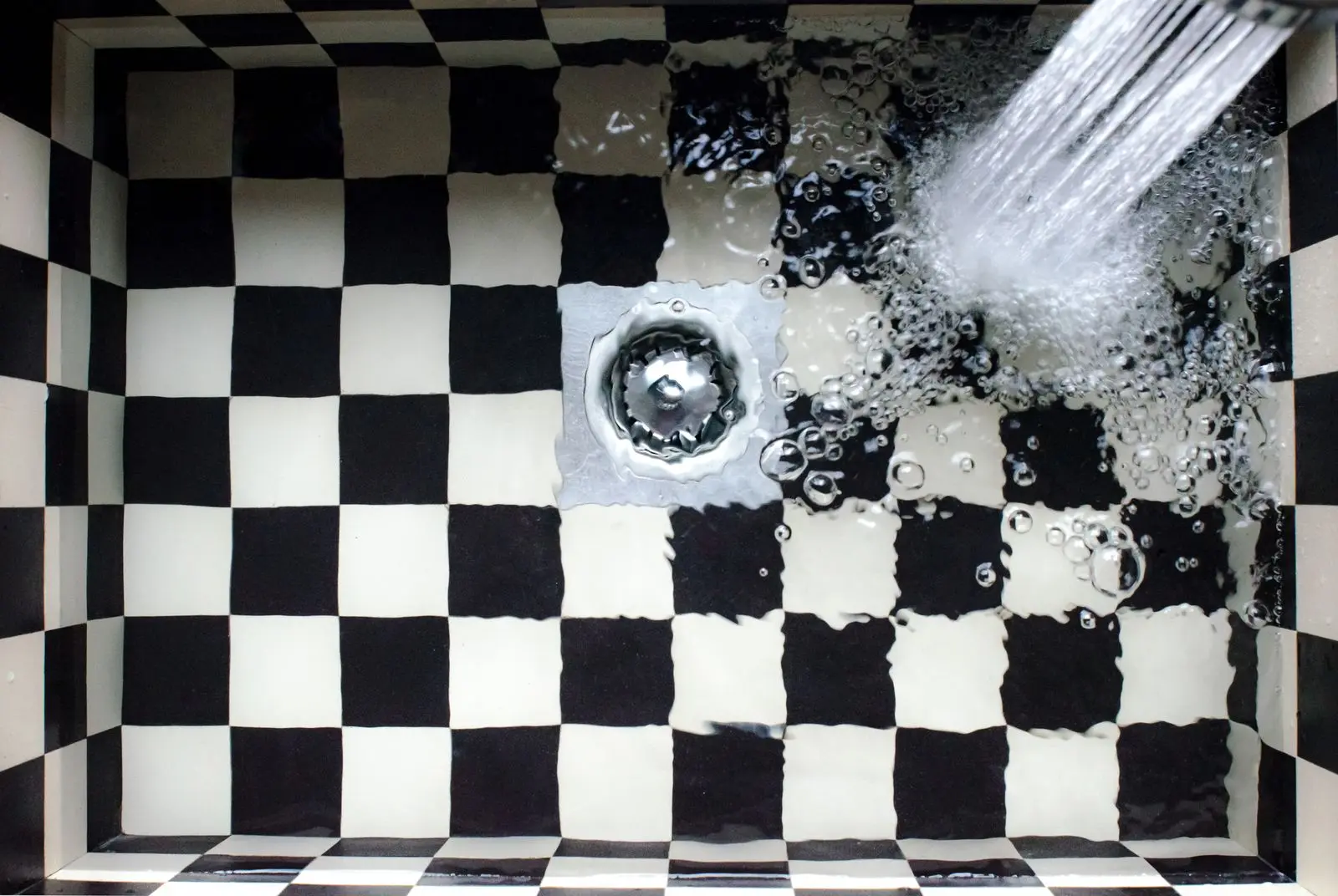 Water swirling down a kitchen sink drain