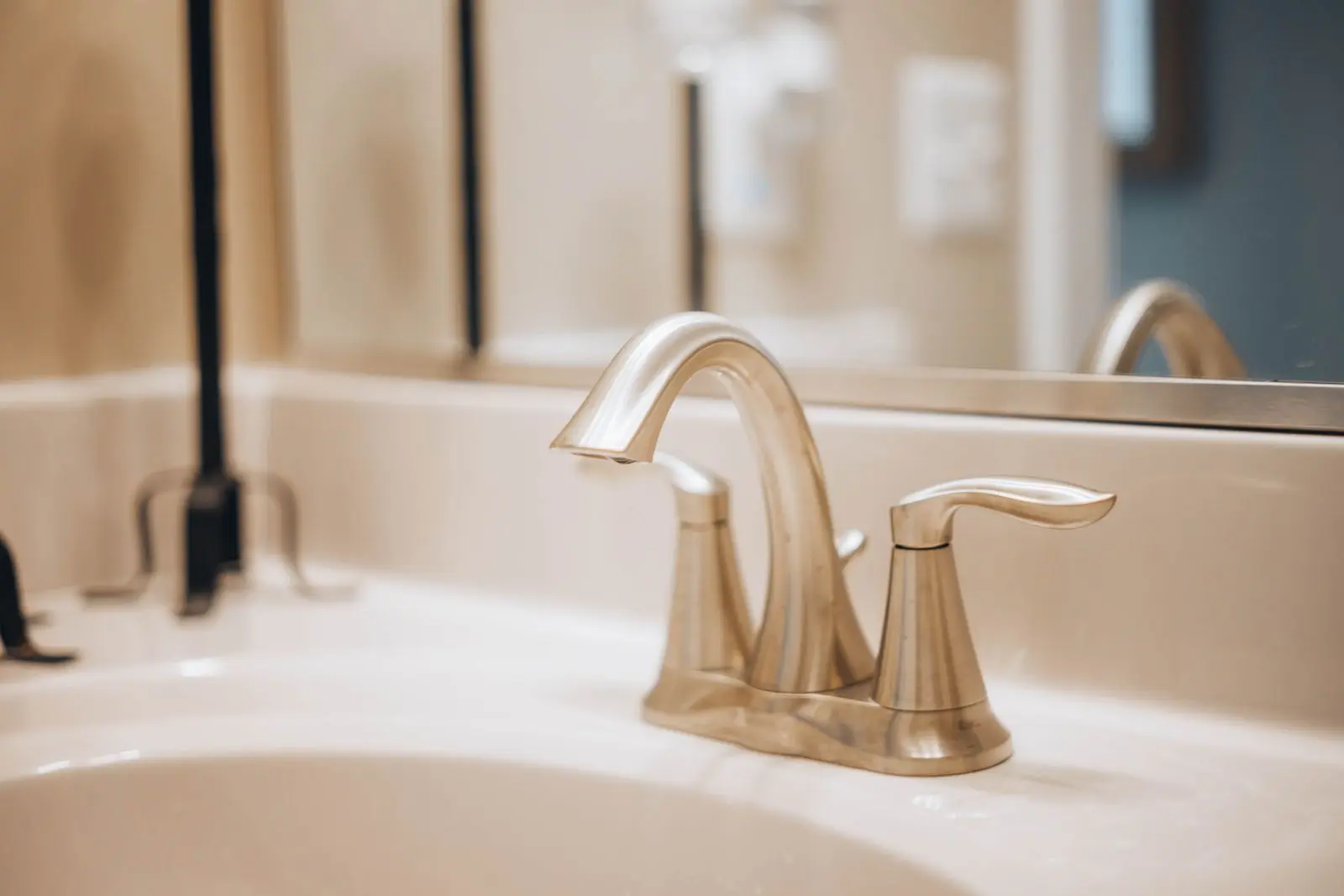 Stainless steel faucet on a white bathroom sink